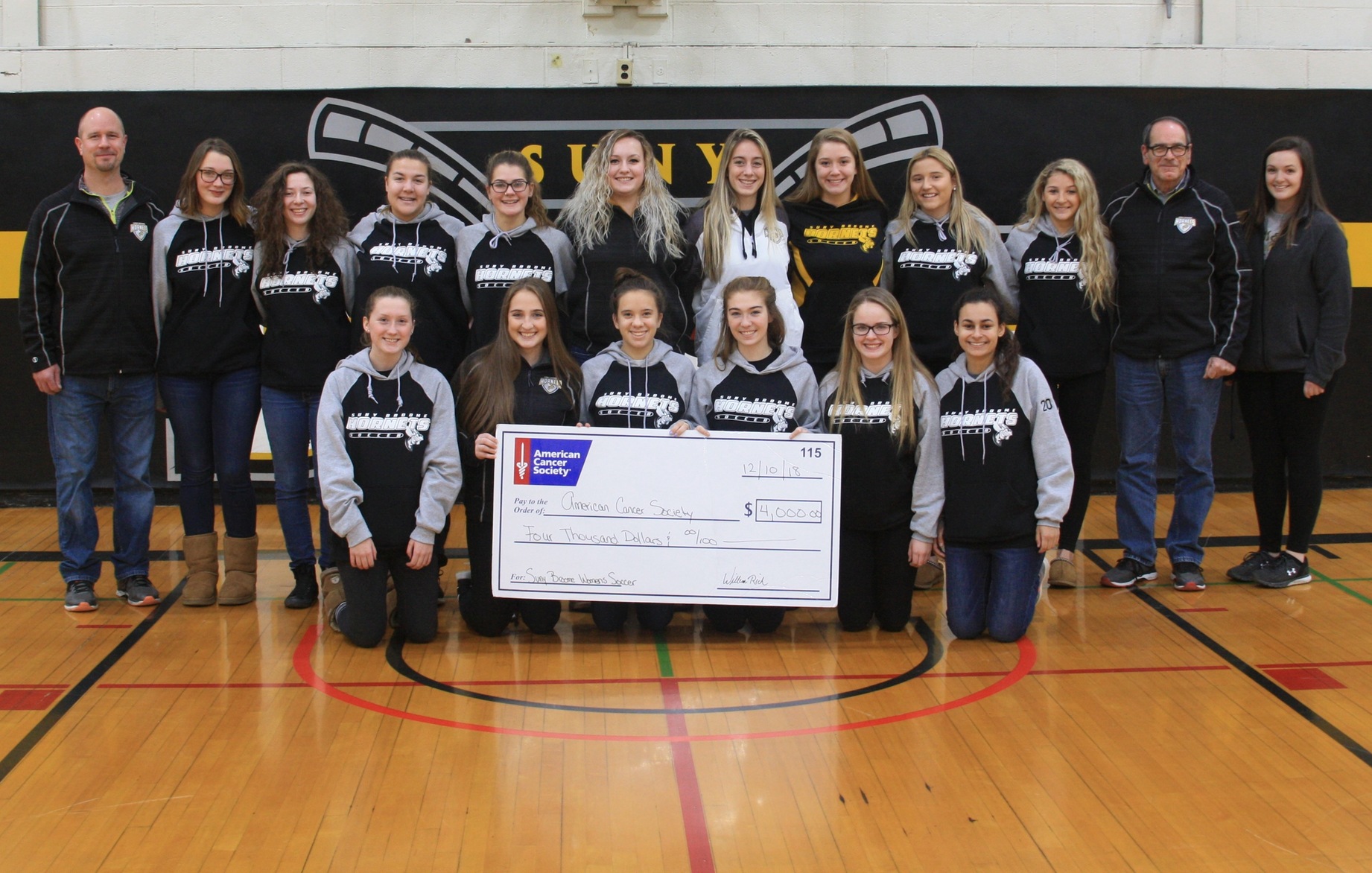 W Soccer Presents Check To ACS