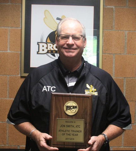 Athletic Trainer holding NJCAA Region III Athletic Trainer of the Year plaque