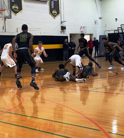 Players diving on floor for loose ball