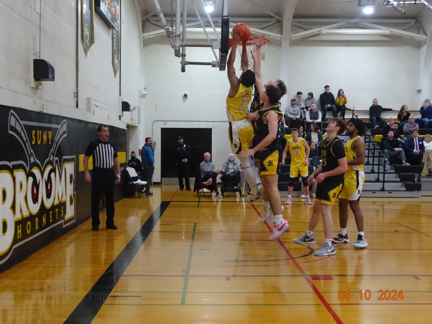 Broome player attempting a dunk against defenders