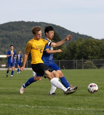 Broome player battling opposition for the soccer ball