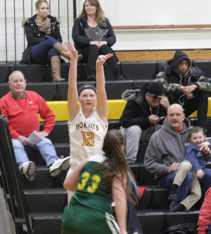 SUNY Broome women's basketball player taking a jump shot from the corner