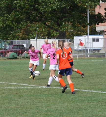 SUNY Broome women's soccer player dribbling around opponent