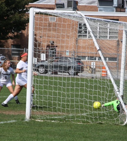 Two Broome players at net scoring goal