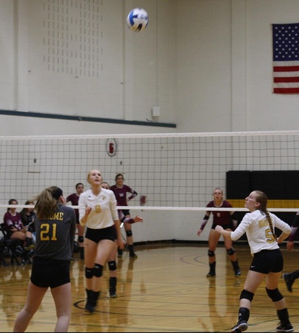 SUNY Broome volleyball player digs ball