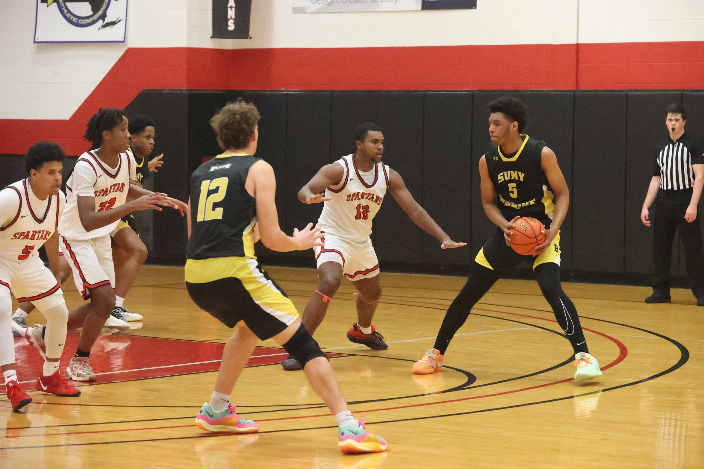 Broome player with the basketball at the top of the key