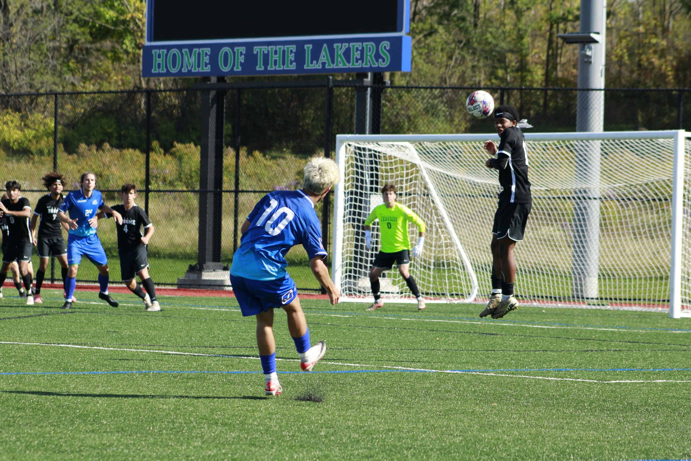 Broome defender tries to deflect an opponent's free kick