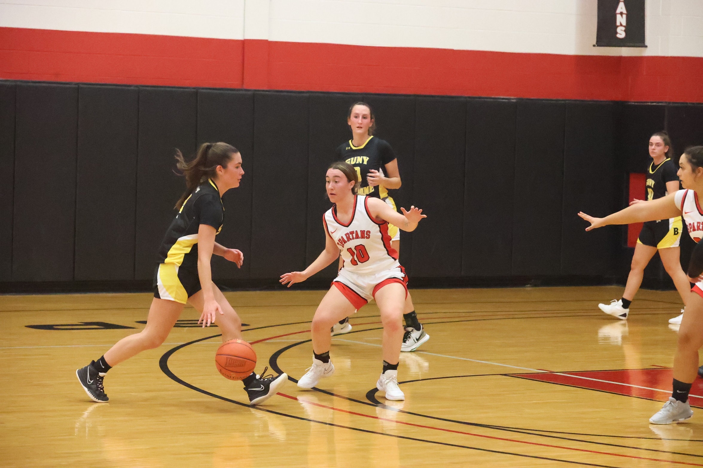 Broome basketball player dribbling past defense