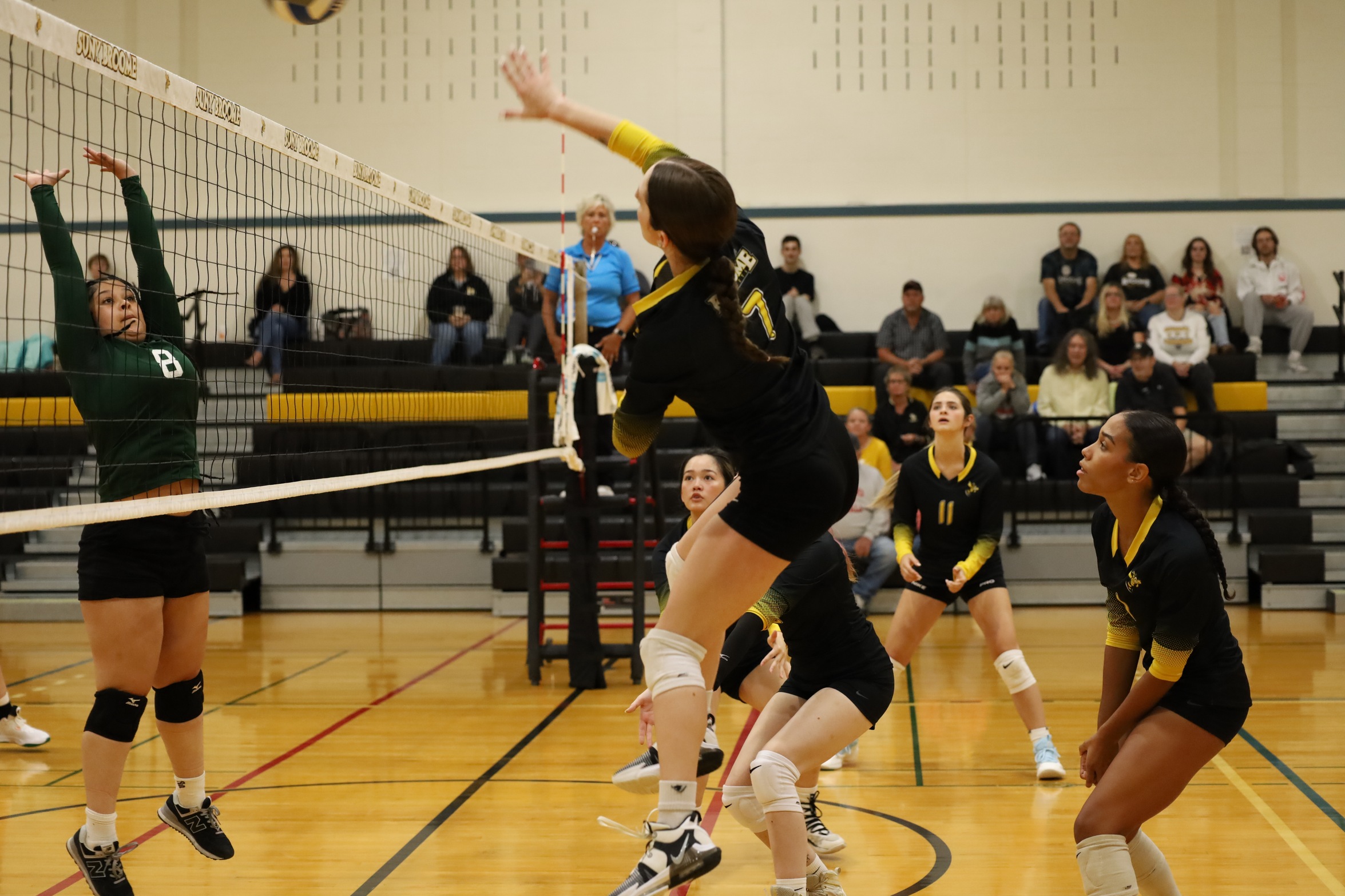 Broome volleyball player hitting ball over net