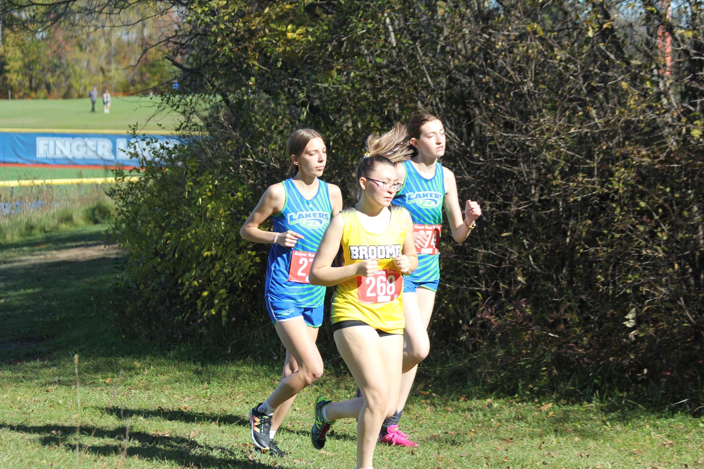 Broome women's cross country runner on the course